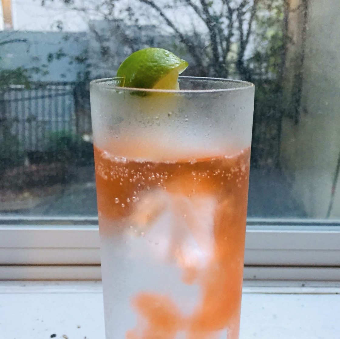 A picture of San Pellegrino with a splash of aperol.