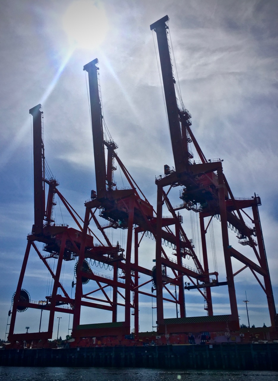 A photo of three Seattle shipping cranes.