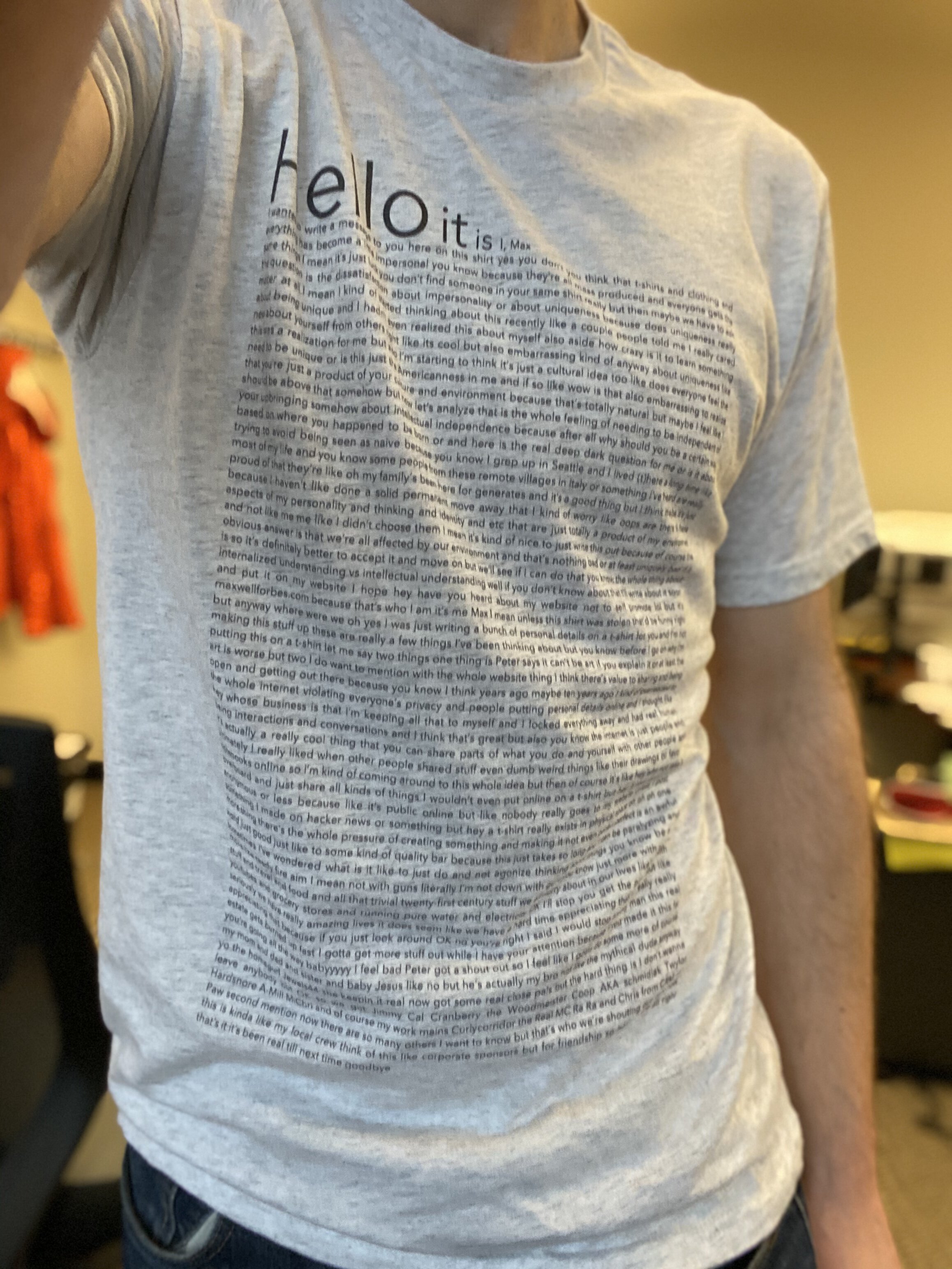 A photo of me wearing the new t-shirt I made, featuring a big wall of text in tiny print